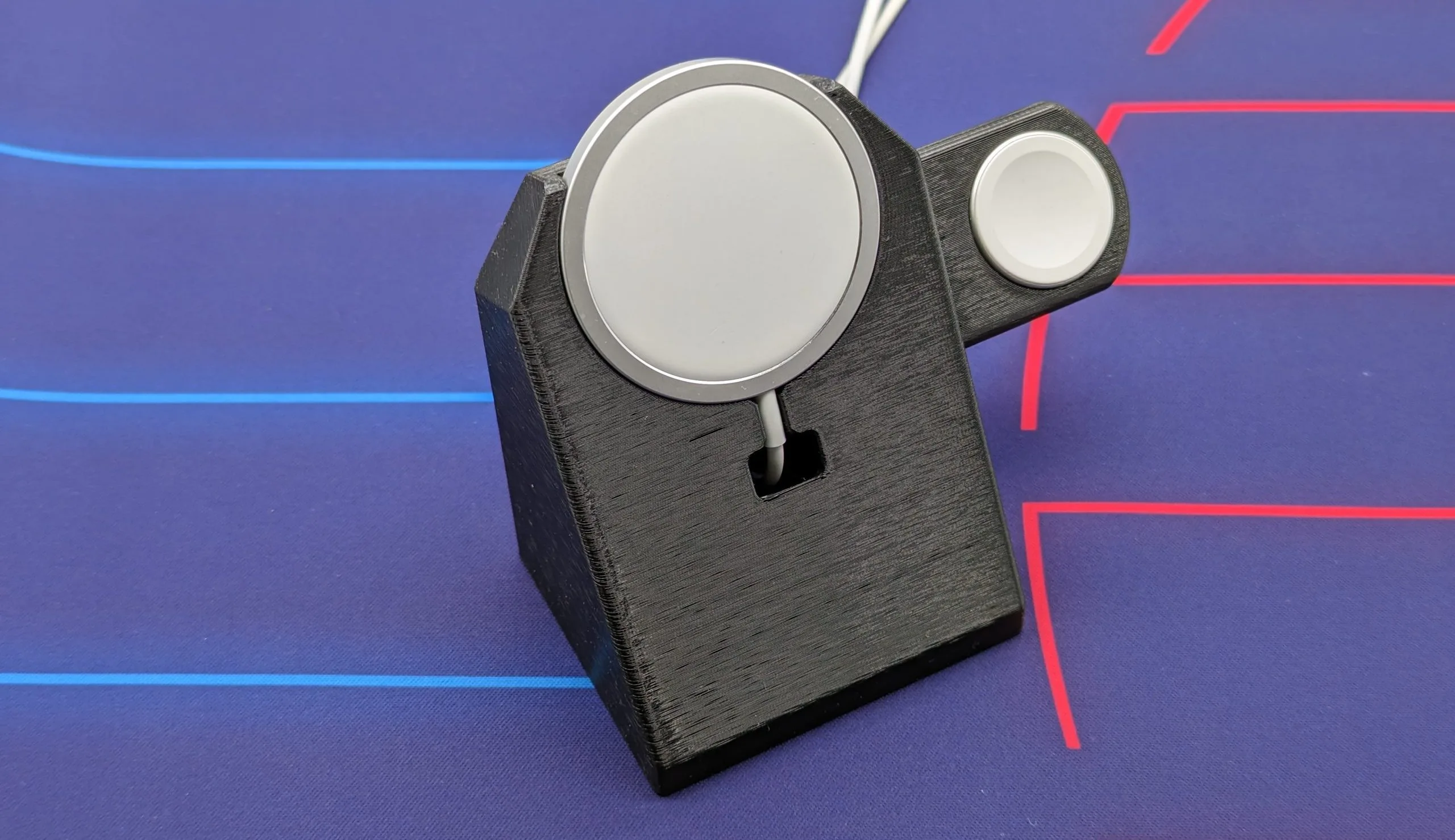 magsafe charger and apple watch charger on a black stand