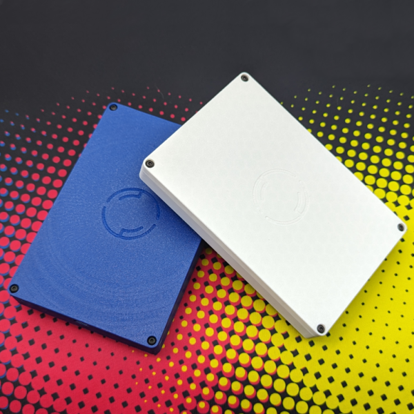 two number pads piled on each other, white and blue cases each of them showing the back with the MatchstickWorks logo debossed in the center