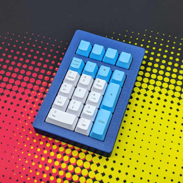 numberpad with a blue 3d printed case, switches with blue and white keycaps are installed