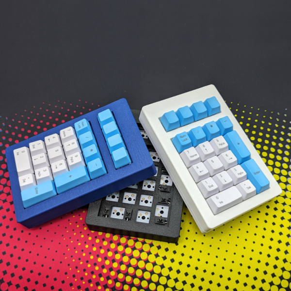 3 number pads stacked on each other, blue white and black cases