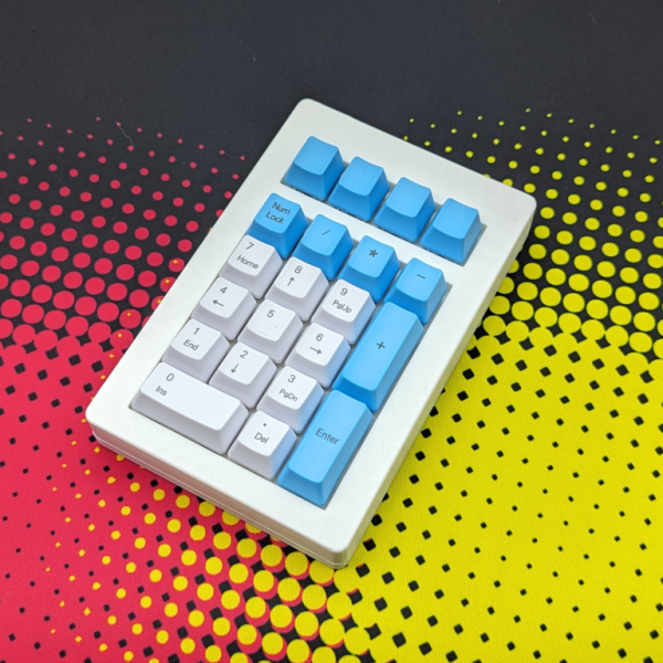 numberpad with a white 3d printed case, switches with blue and white keycaps are installed