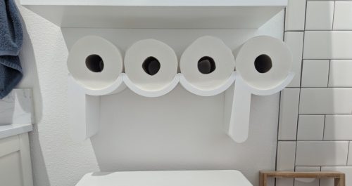 3d printed shelves for toilet paper rolls which comically spell out the word "poop" when the toilet paper is placed in place