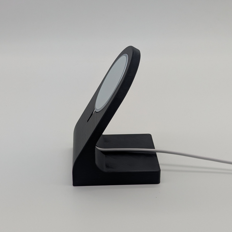 a 3d printed phone charging stand in black viewed from the side